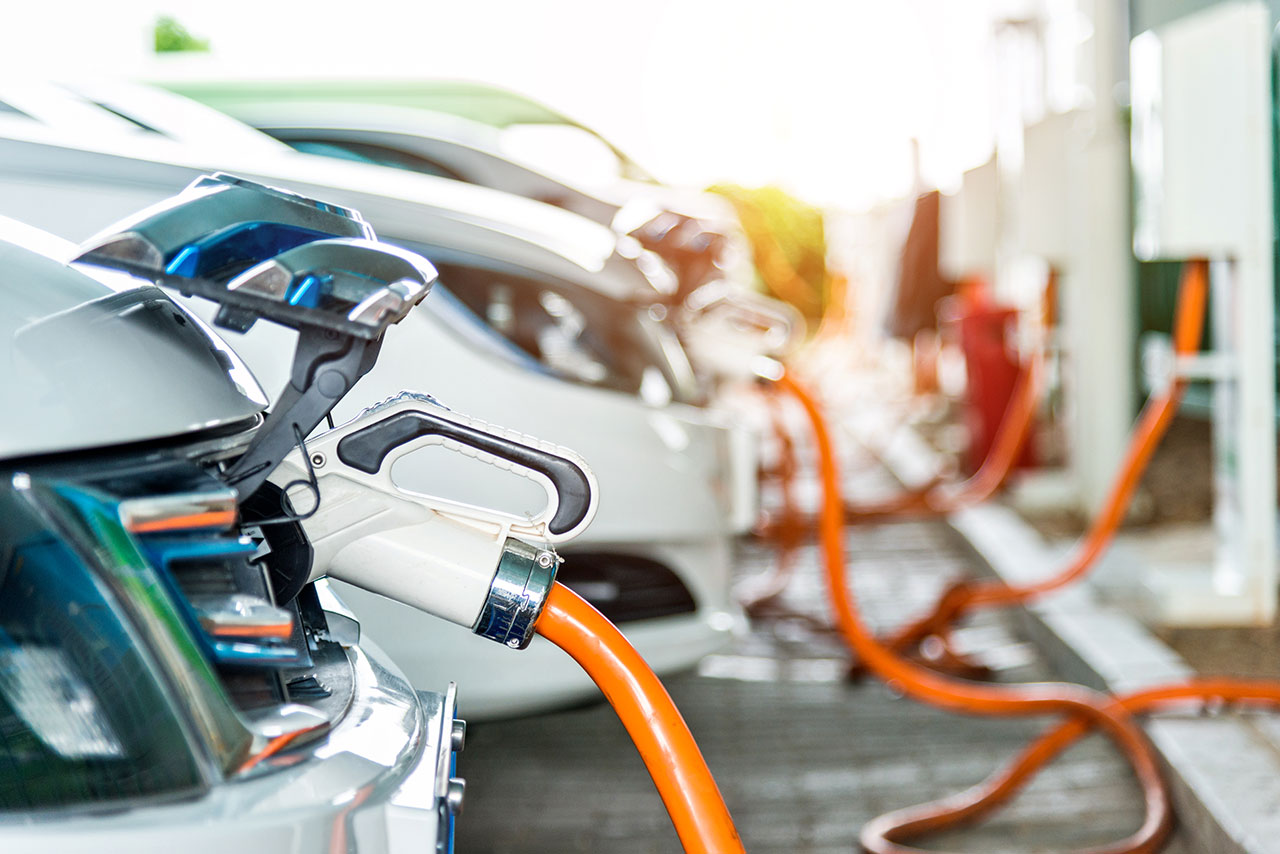 Image of cars plugged into charging ports. 