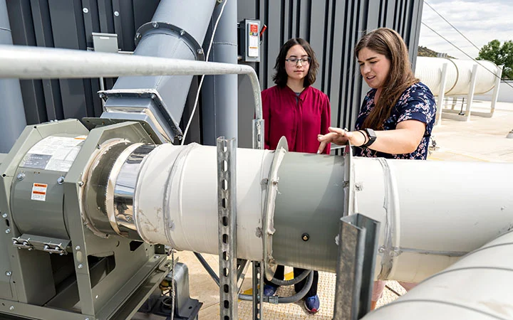 research-workforce-81975 A mentor and an intern looking at equipment.
